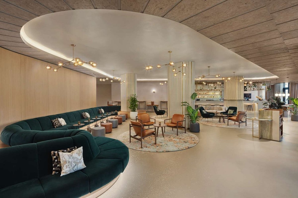 Hilton London Paddington lobby and lounge with curved velvet sofas and brass pendant lighting